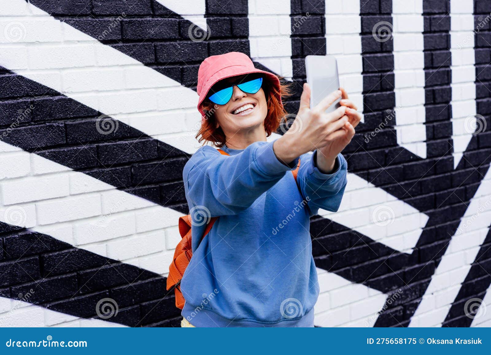 Hipster fashion woman in bright clothes, heart shaped glasses