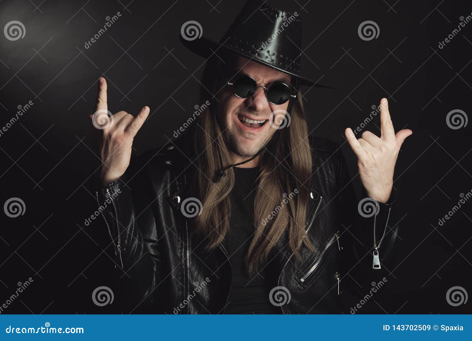 Punk rocker making a hardcore hand gesture Stock Photo by