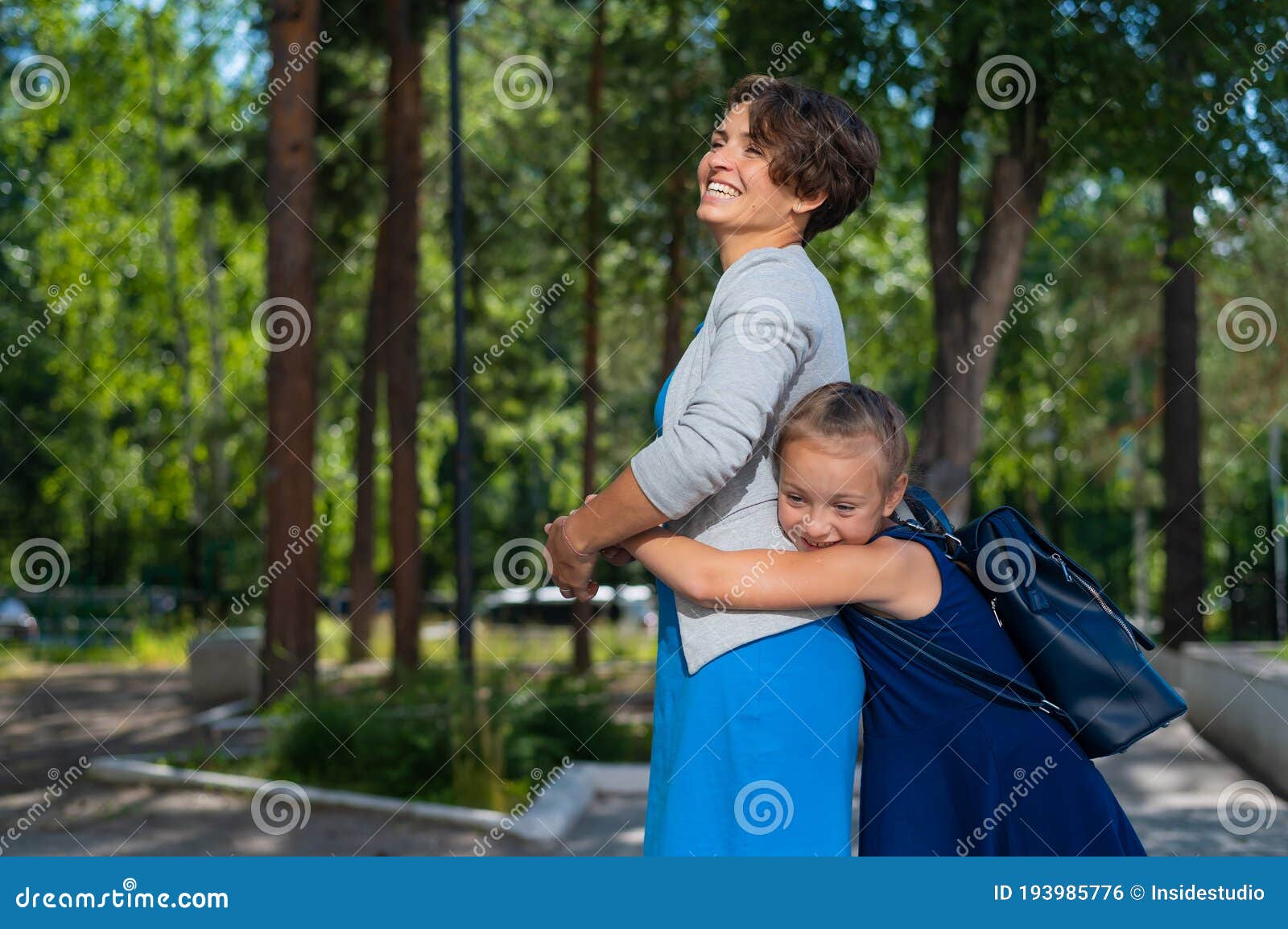 Excited Schoolgirl Hugs Mom Behind Her Back The Girl Missed Her Mother