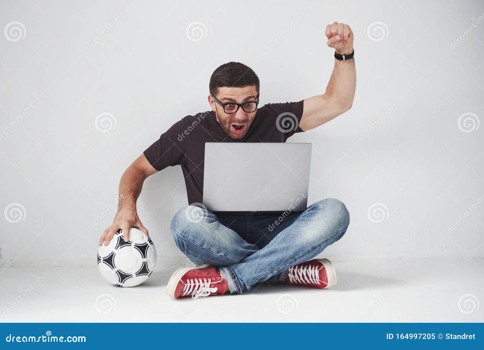 Excited Soccer Fan with a Football Isolated on White Background