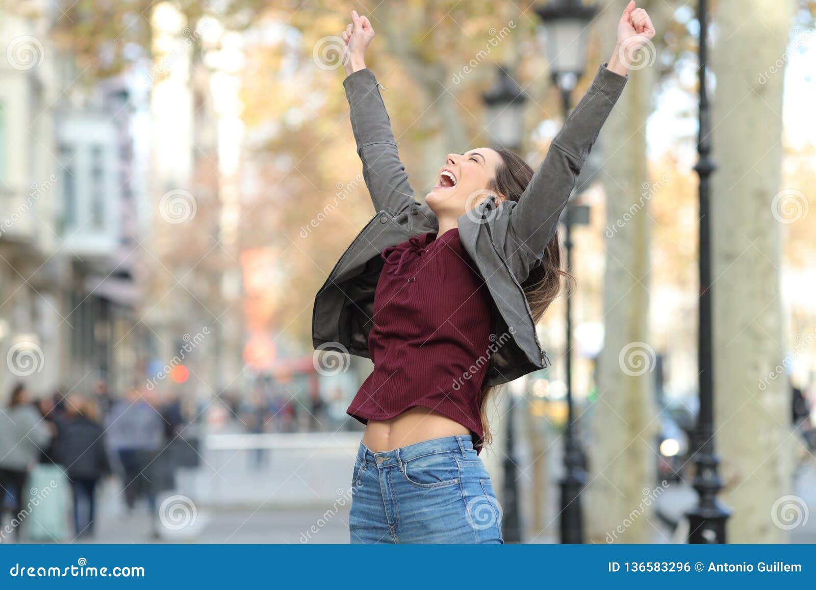 excited woman jumping in the street