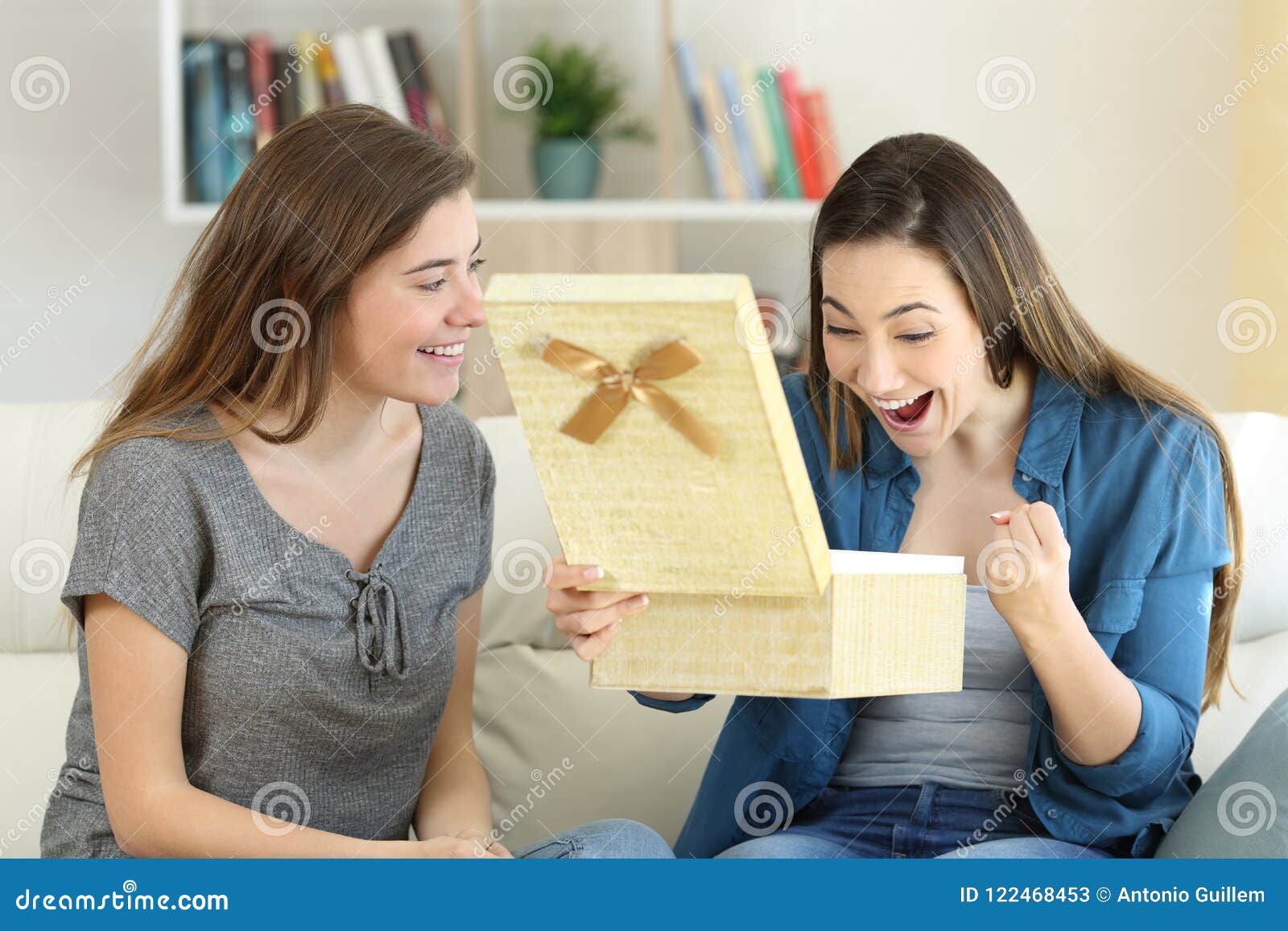 excited woman receiving a gift from a friend