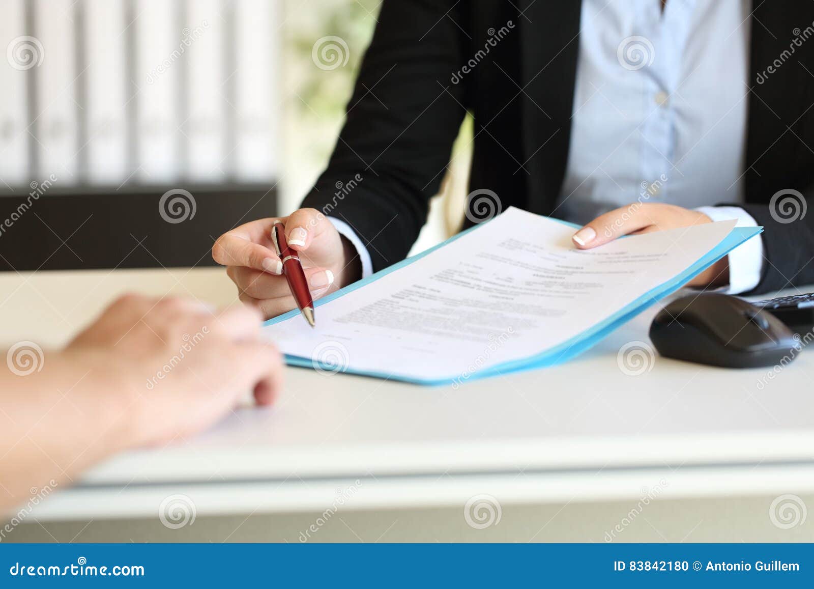 executive hands indicating where to sign contract