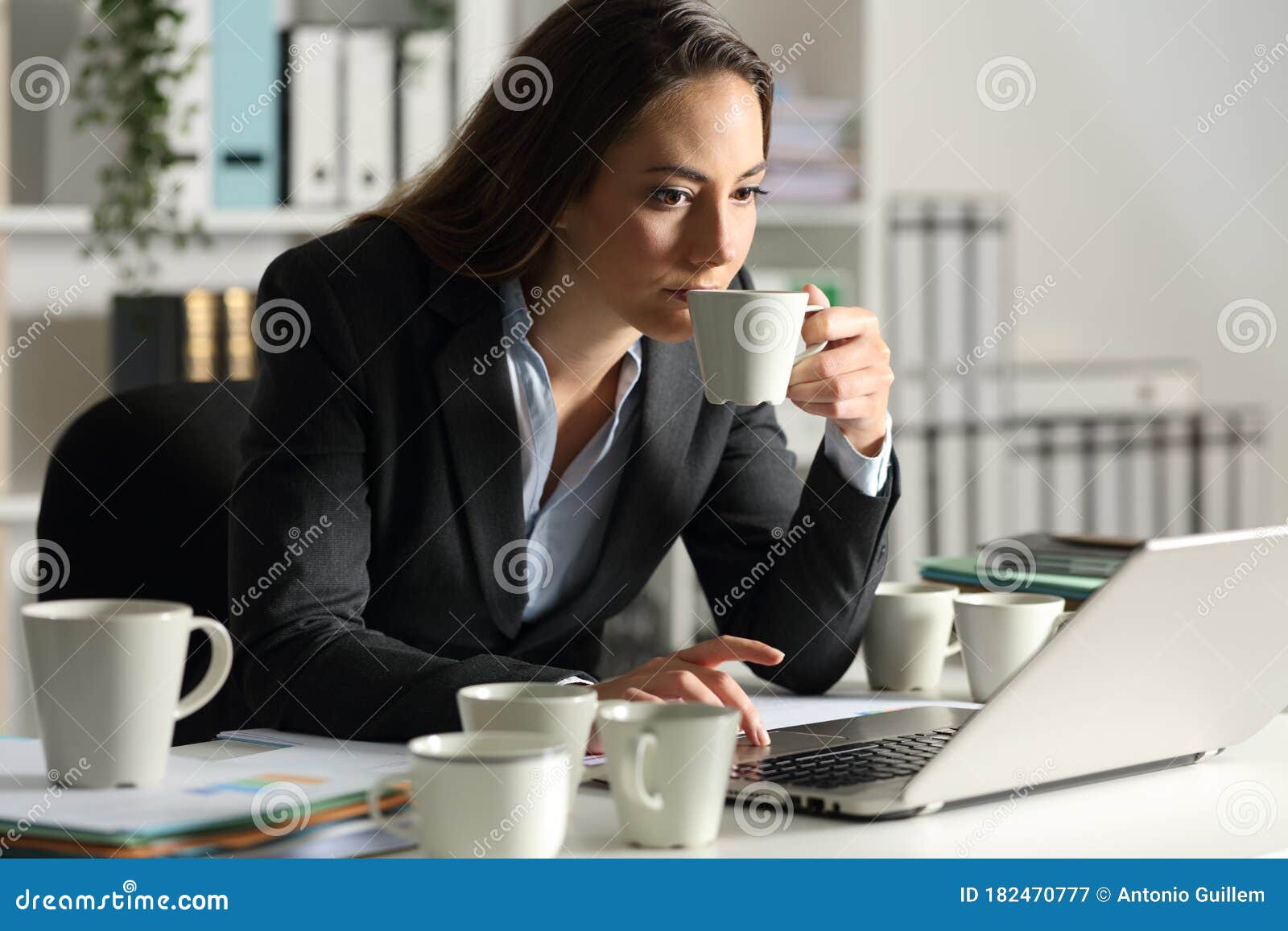 executive overworking needing caffeine at night at office
