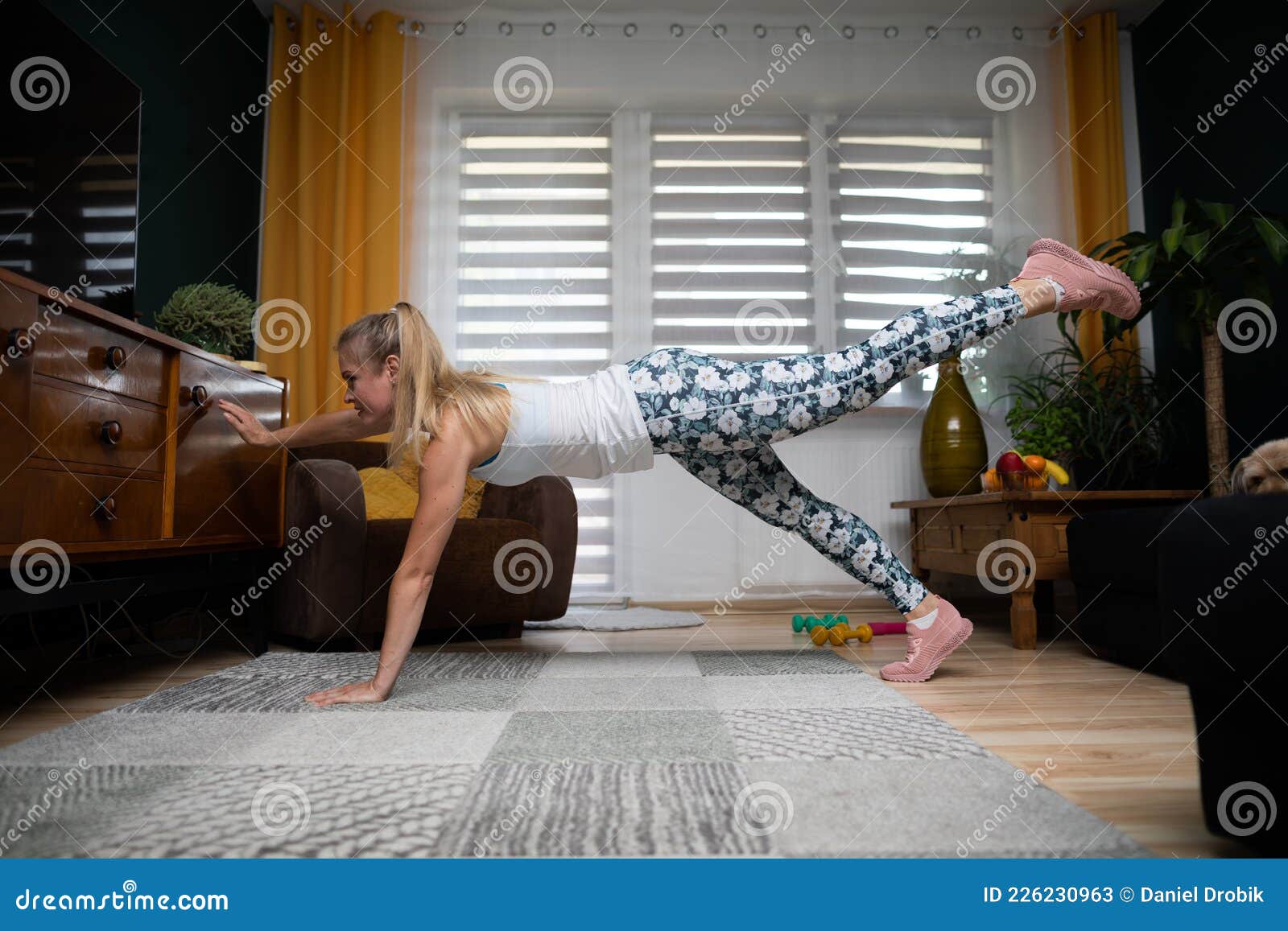 A 20-year-old female trainer practices Pilates on an elevator