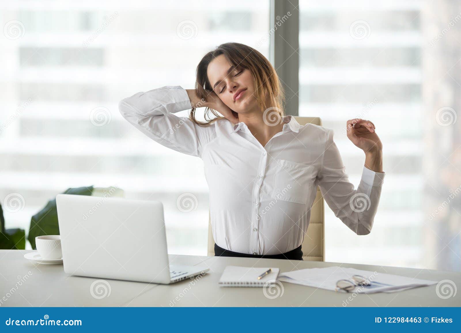 exhausted businesswoman taking break from sedentary work stretch