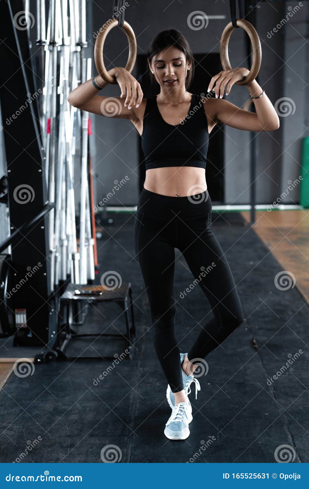 Woman holding gymnastic rings in gym