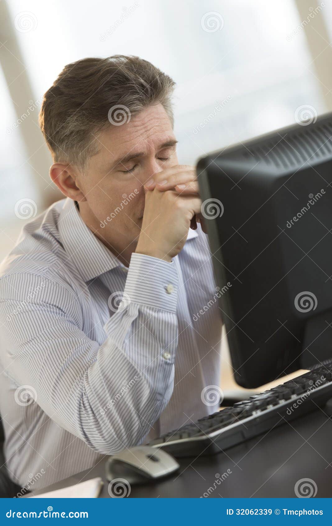 Exhausted Businessman Leaning On Computer Desk Stock Image Image