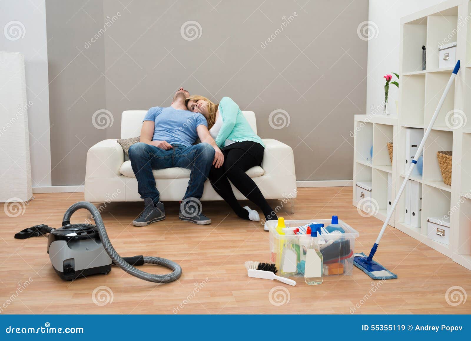 exhausted couple on sofa in living room