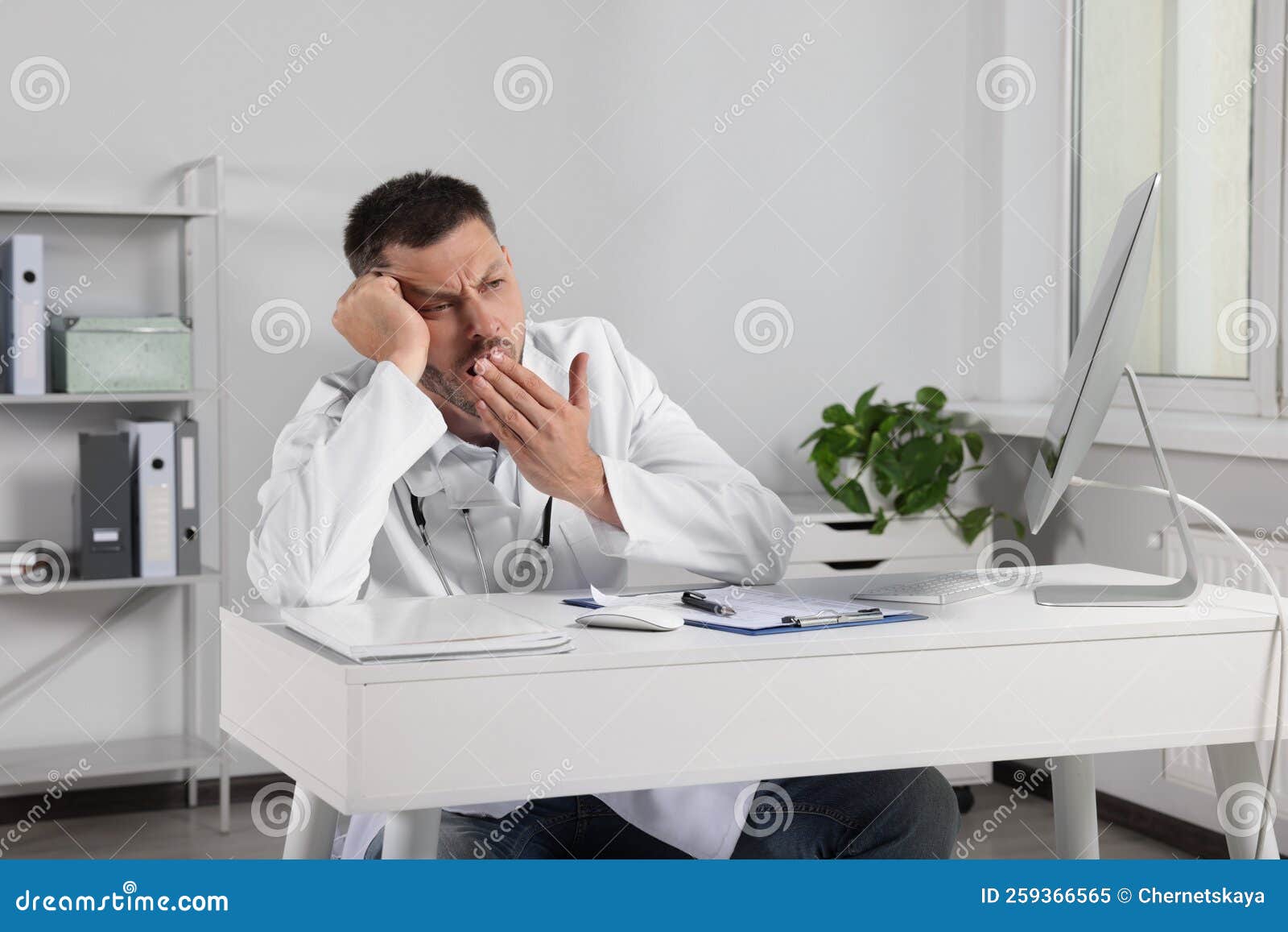 Exhausted Doctor Yawning at Workplace in Hospital Stock Image Image
