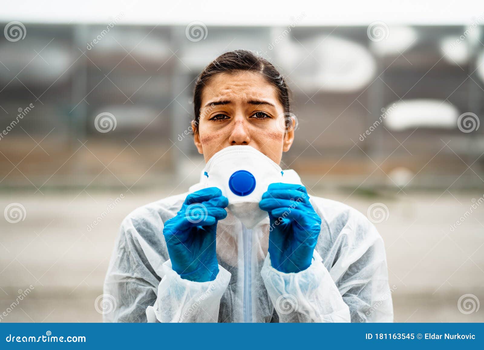 exhausted emotional doctor/nurse wearing coronavirus protective gear n95 mask.coronavirus covid-19 pandemic outbreak.frontline
