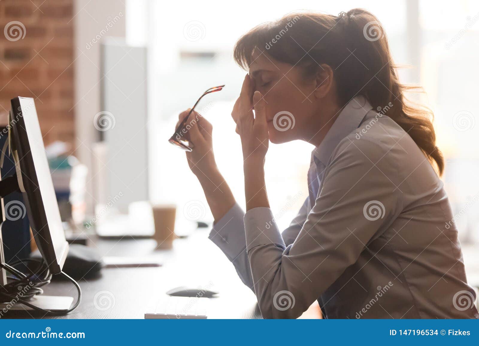 tired female employee suffer from headache at workplace