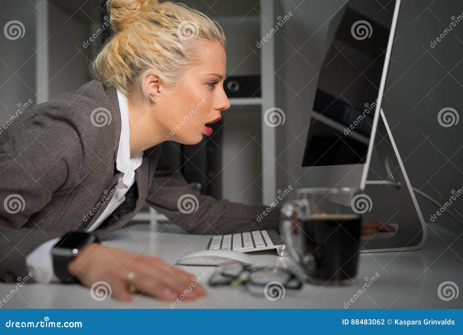 Exhausted and Tired Woman Looking at Computer Screen Very Close Stock
