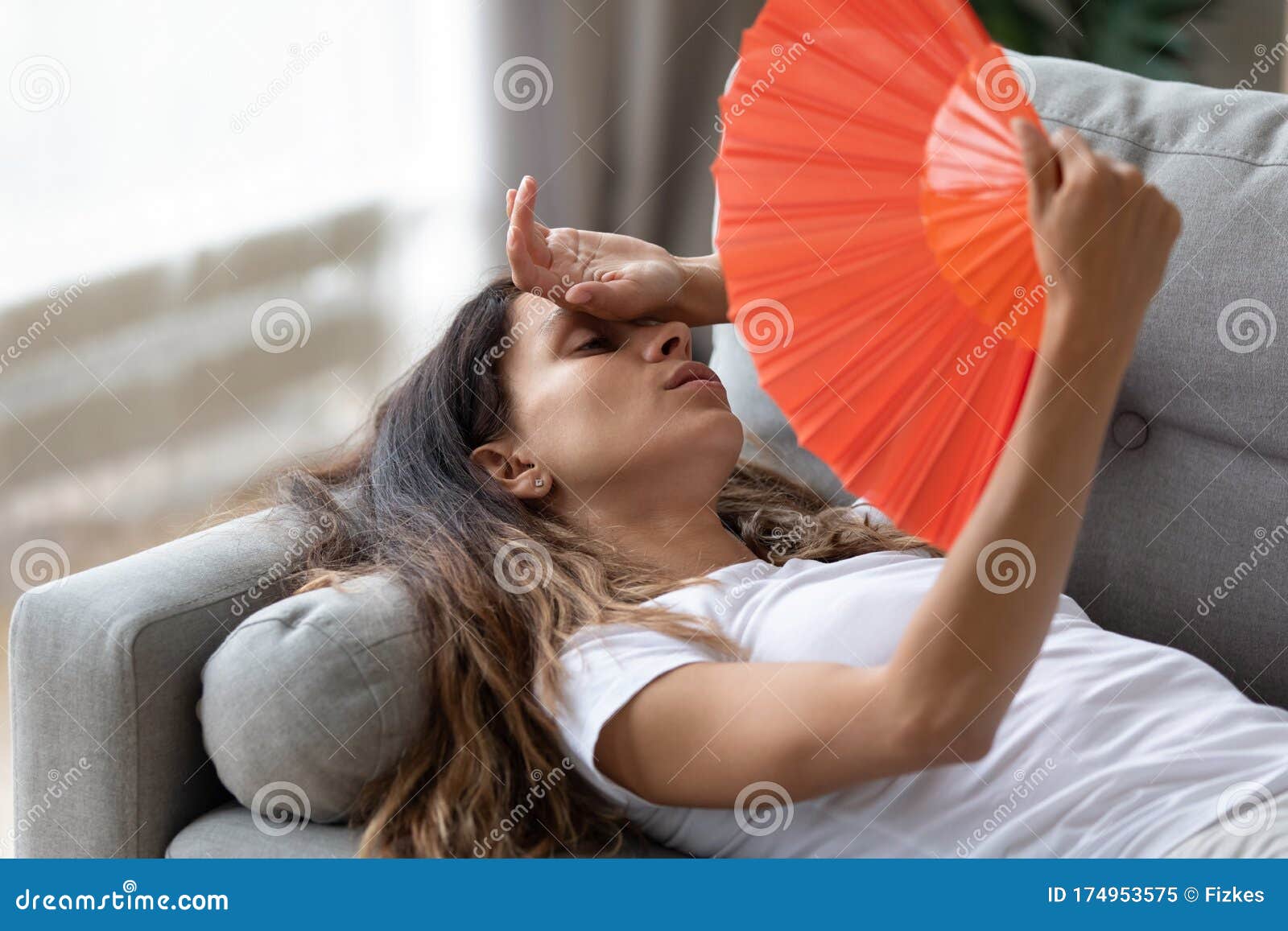 exhausted woman use hand fan suffer from heat