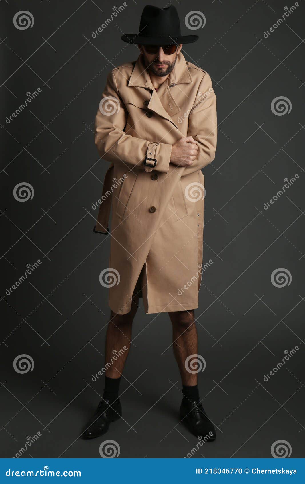 Exhibitionist Exposing Naked Body Under Coat On Black Background Royalty Free Stock Image