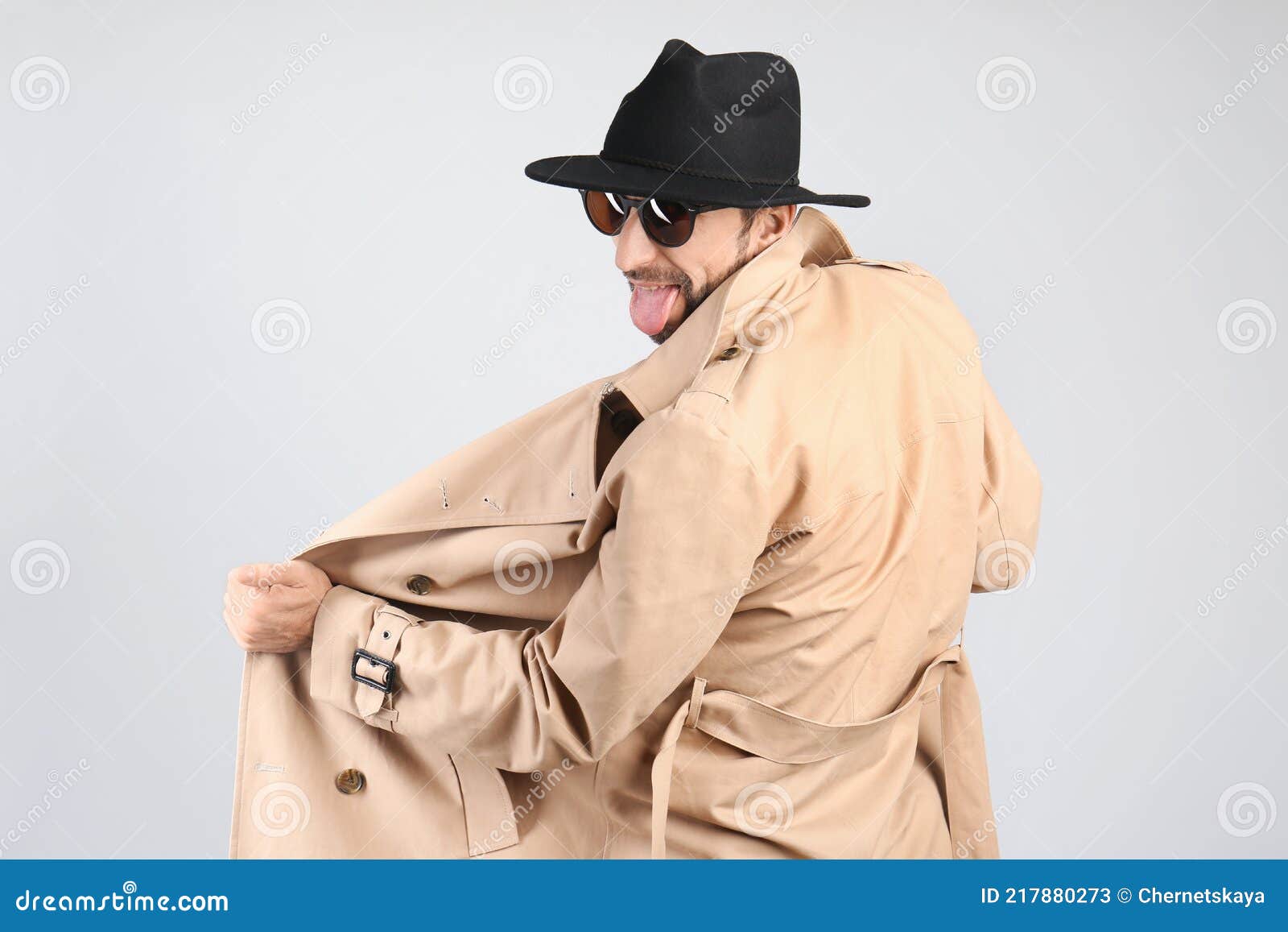 Exhibitionist Exposing Naked Body Under Coat on Light Background Stock