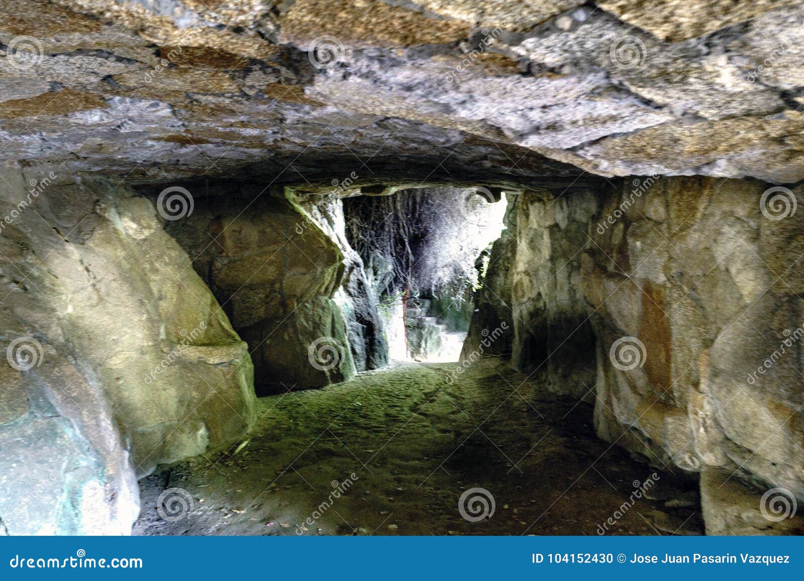 exit covered with vegetation in an artificial stone cave. park o