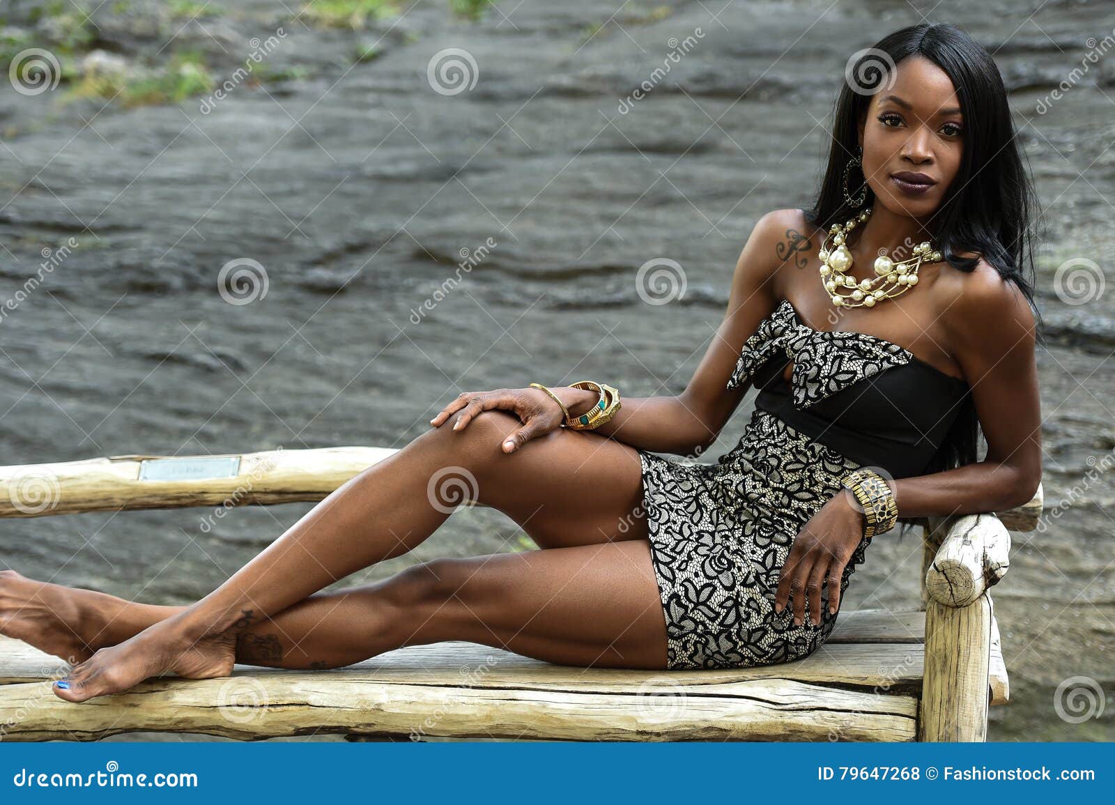 exotic looking african american woman sitting on the bench.