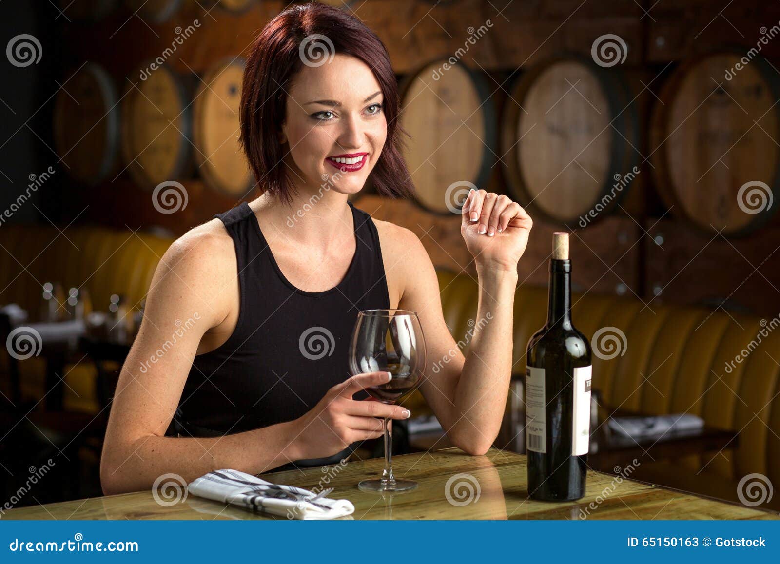 Exotic Beautiful Woman on a Dinner Date at Winery Barrels Enjoying