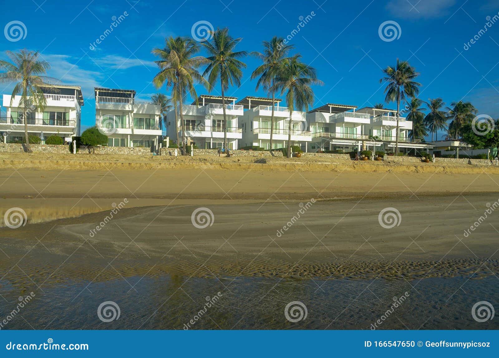 exotic tropical vibrant coastal resort waterscape with holliday homes in a blue sky over ocean water. thailand