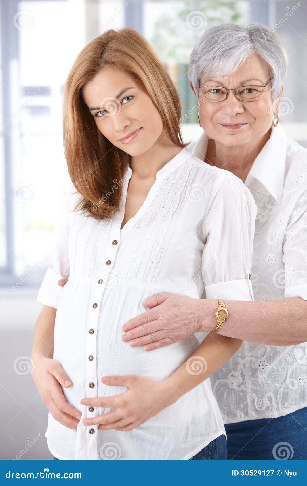 expectant woman and senior mother smiling