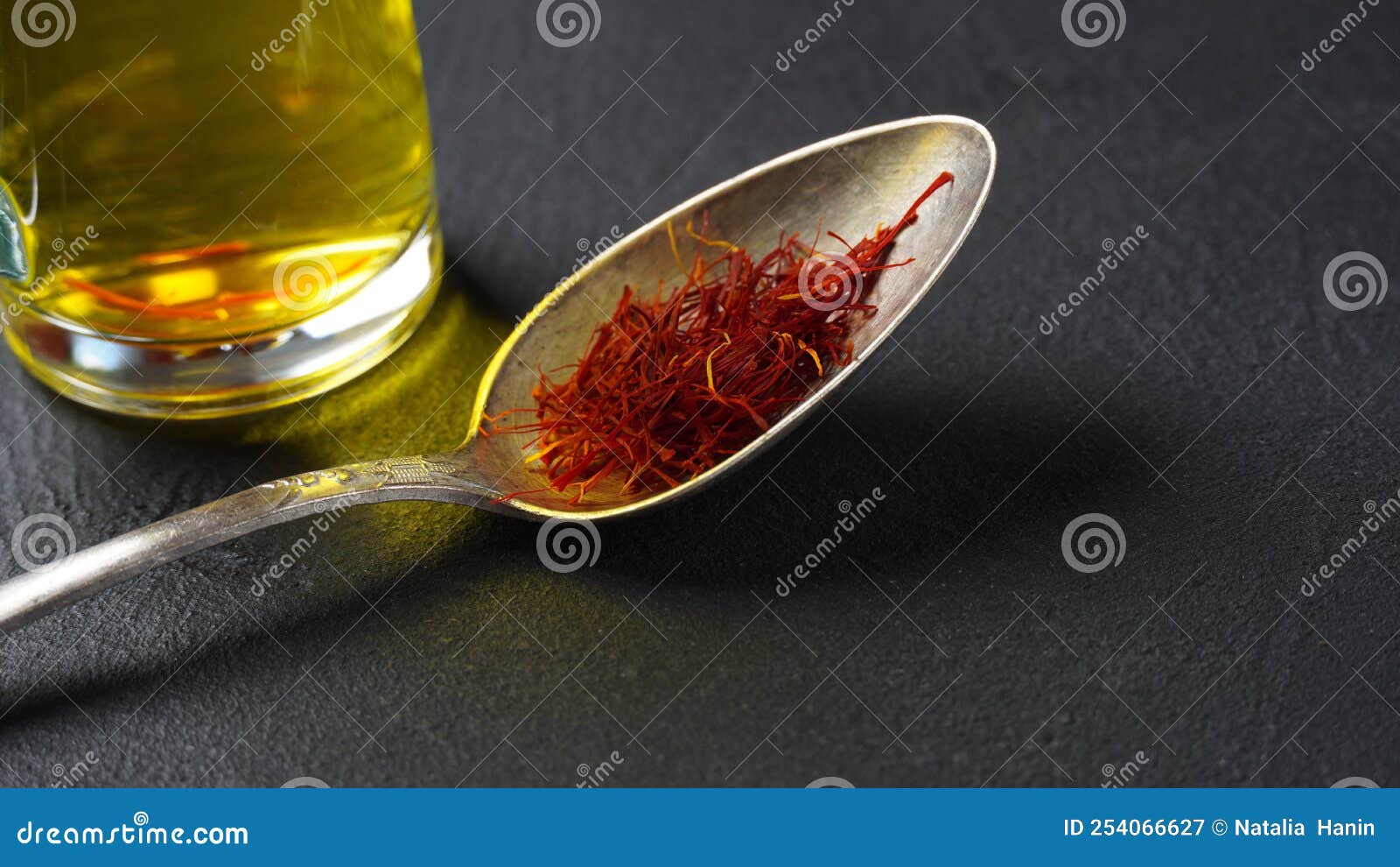 Expensive Red Dried Saffron Spice in a Spoon on Dark Background Stock
