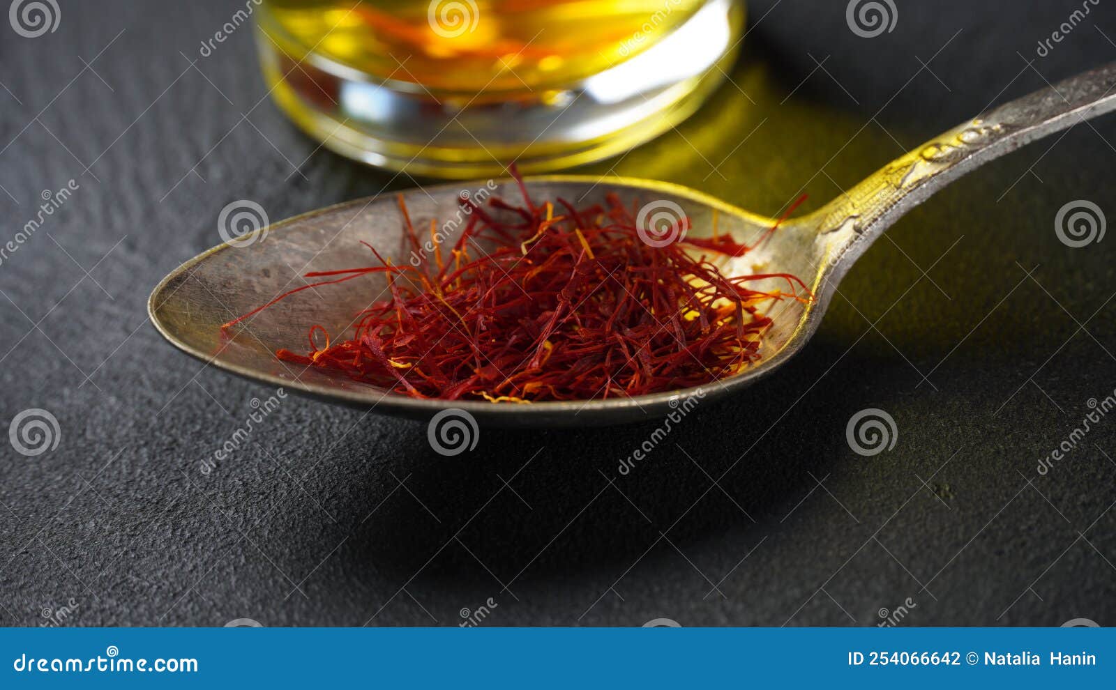 Expensive Red Dried Saffron Spice in a Spoon on Dark Background Stock