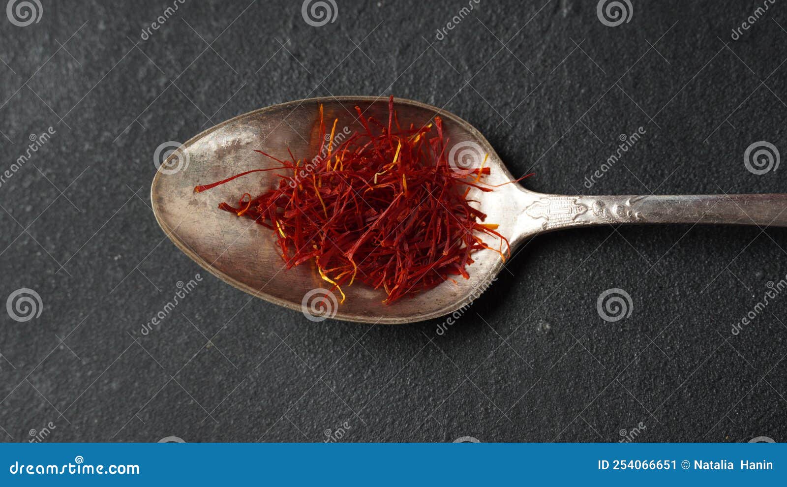 Expensive Red Dried Saffron Spice in a Spoon on Dark Background Stock