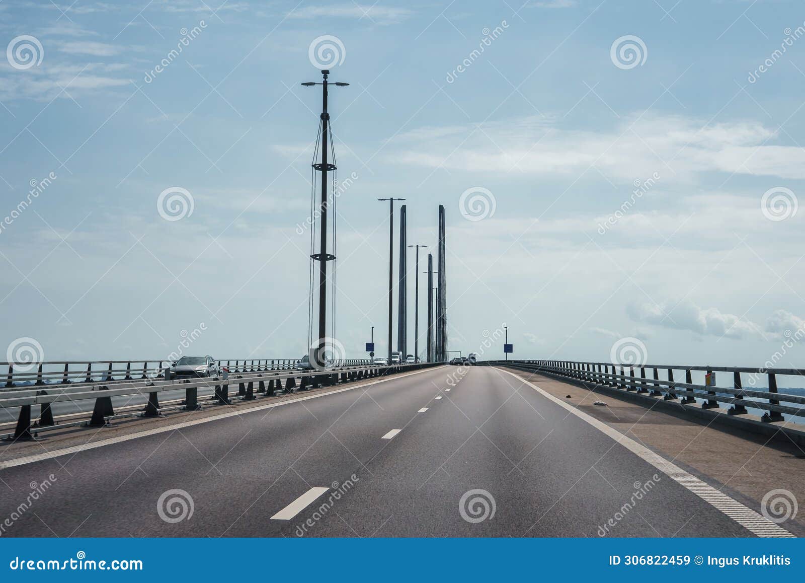 experience the modern oresund bridge with a clear sky and serene sea view.