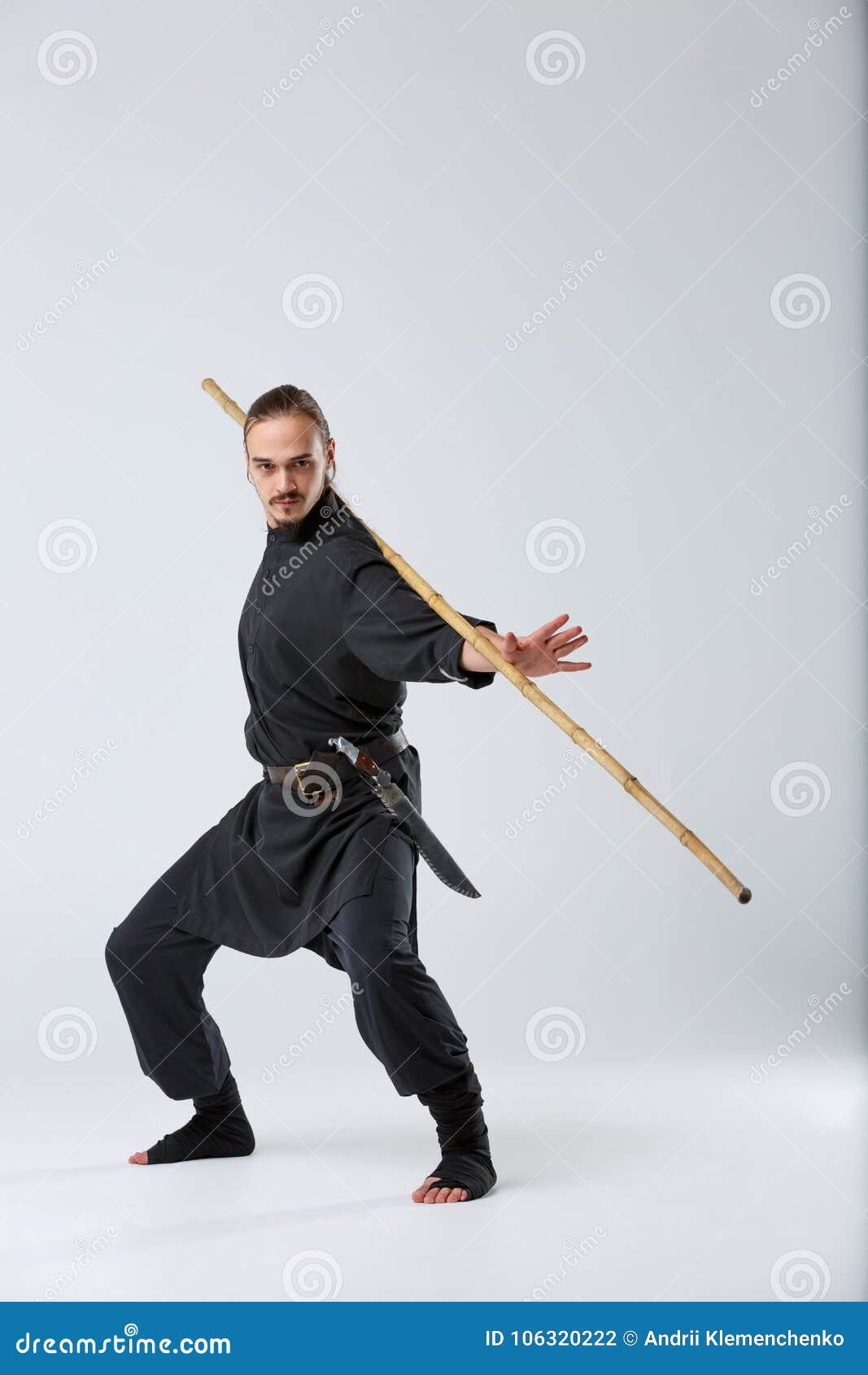 An Experienced Fighter Man, Works Out a Combat Movement with a Long Bamboo Fighting  Stick. Stock Photo - Image of block, japanese: 106320222