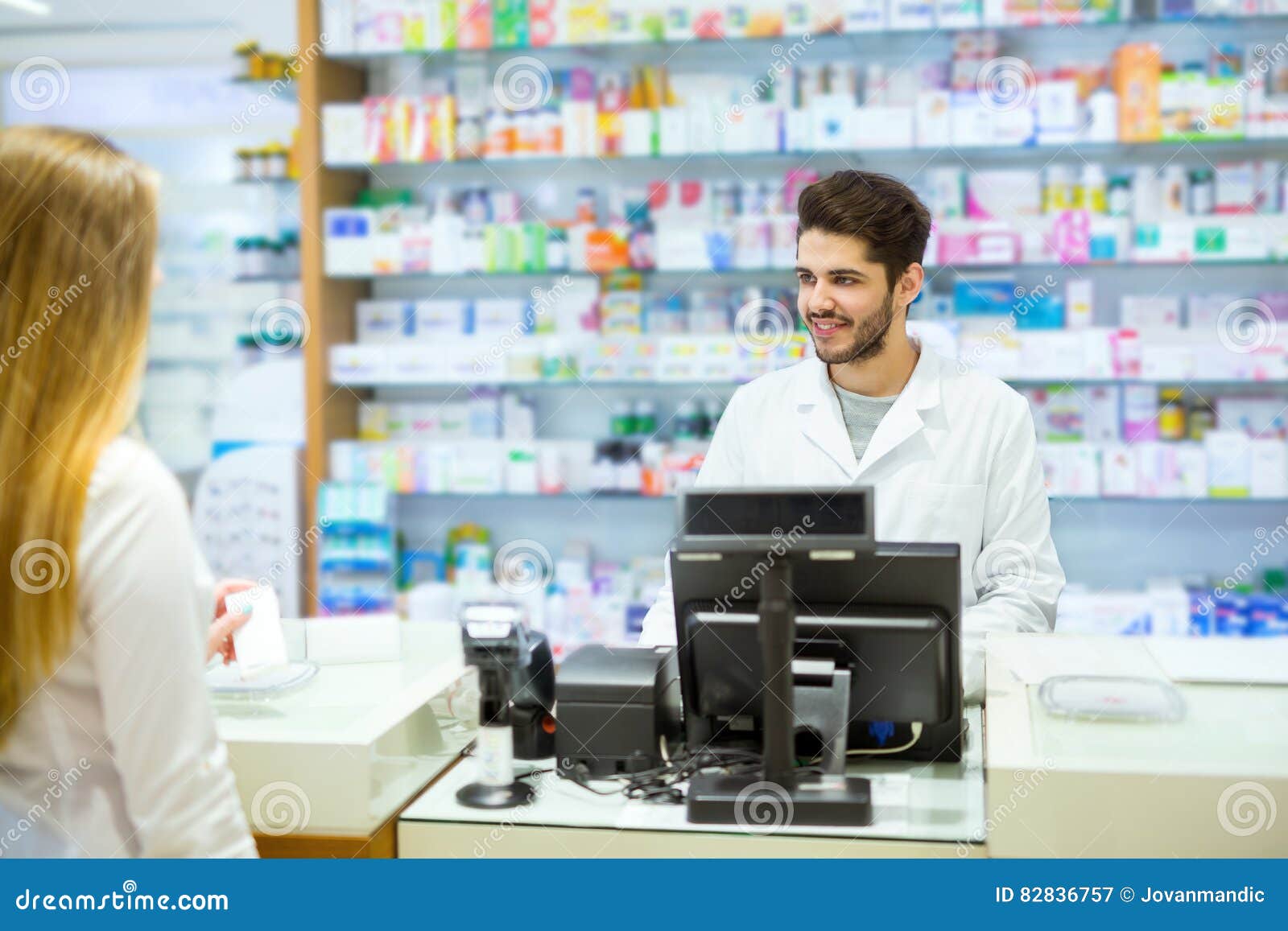 Experienced Pharmacist Counseling Female Customer in Pharmacy Stock