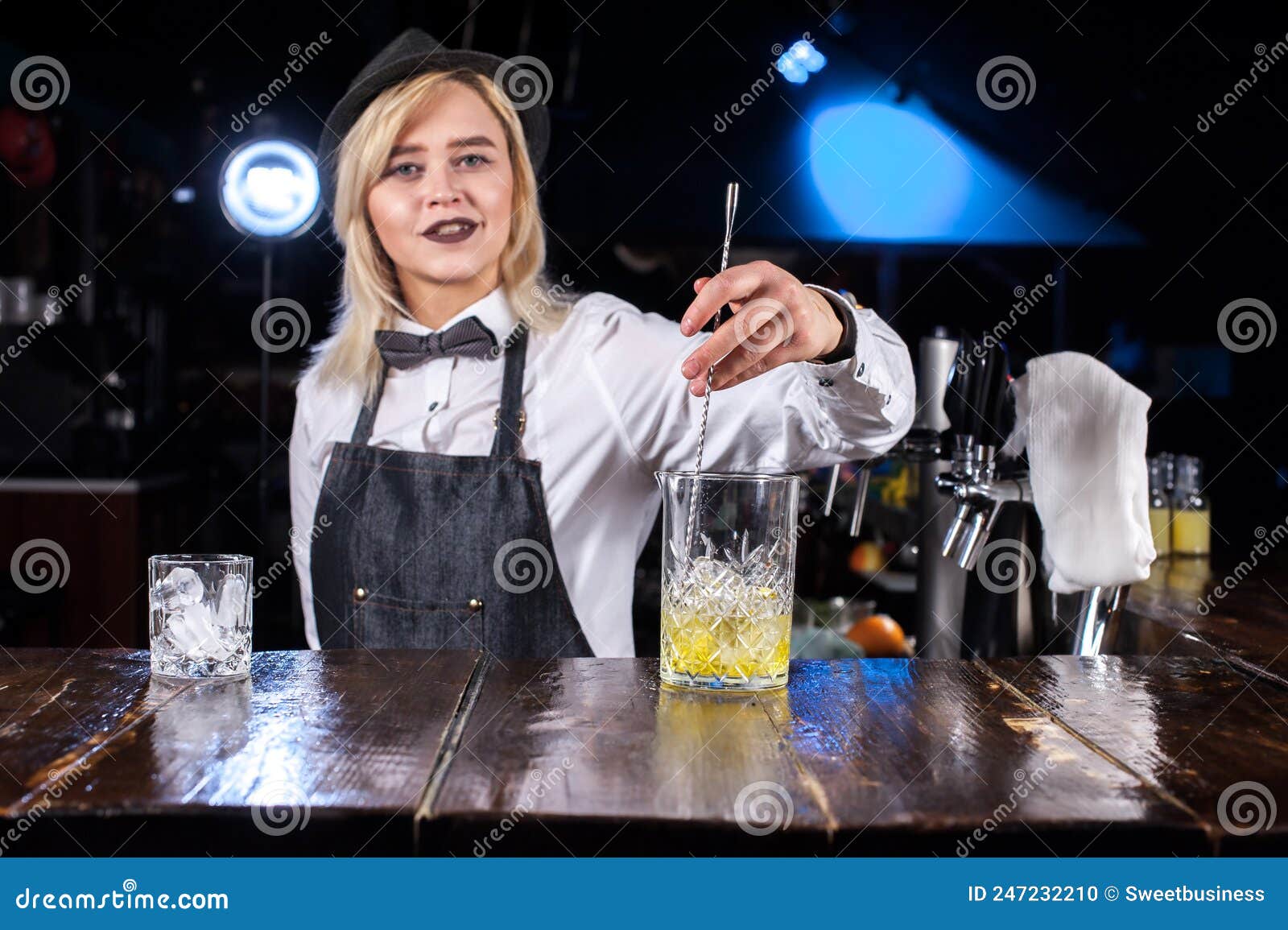 Professional Woman Mixologist Creates a Cocktail while Standing Near ...