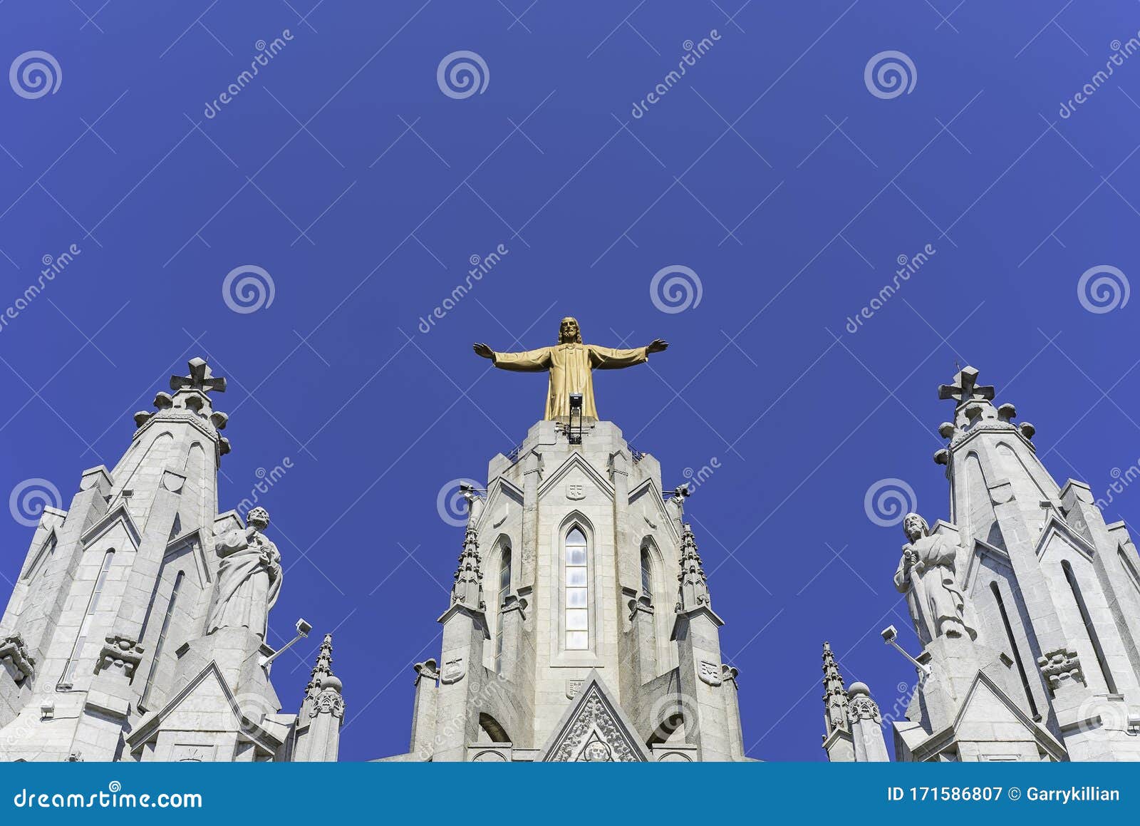 the expiatory temple of the sacred heart in barcelona, spain. with a classic blue sky.