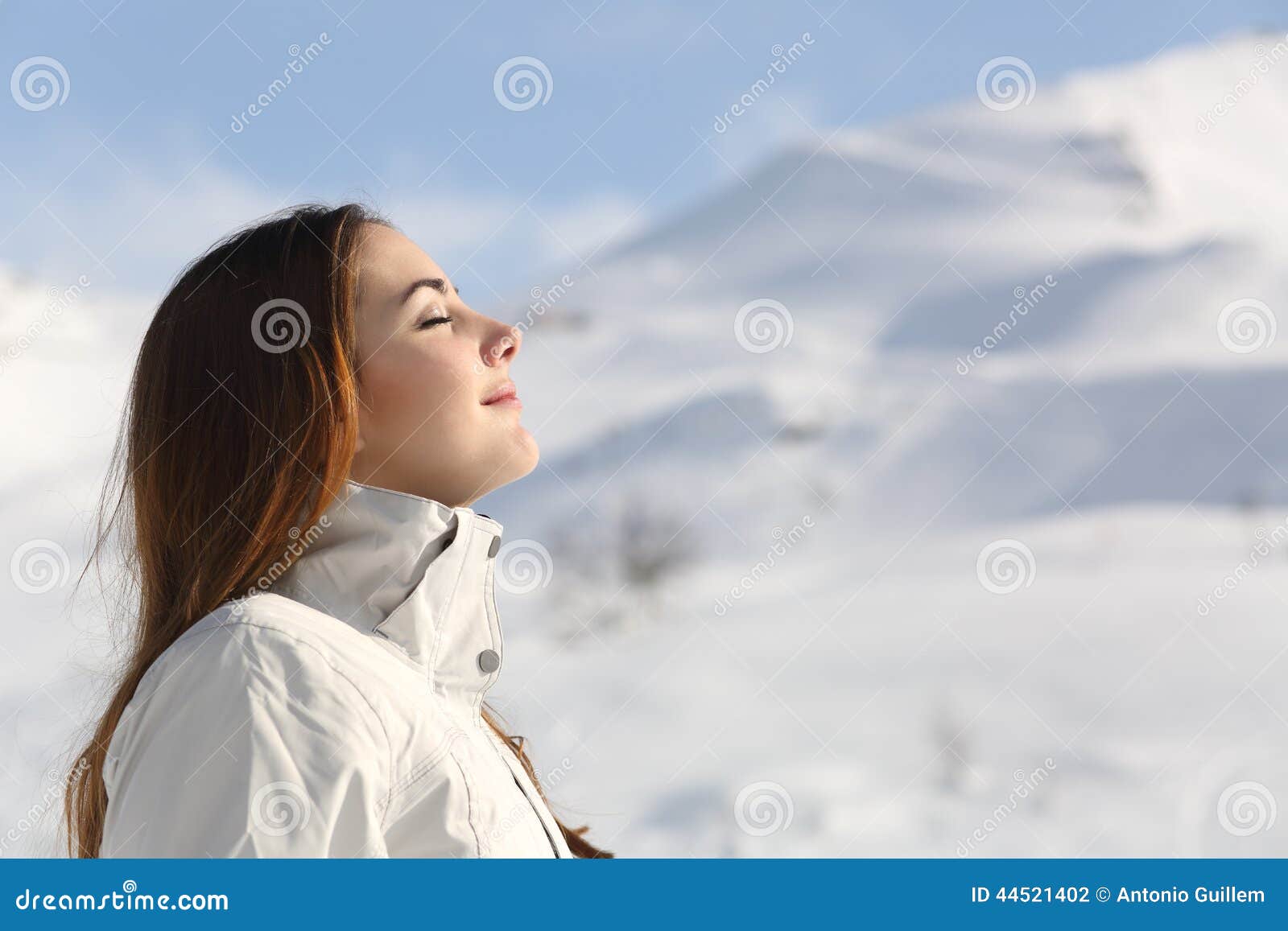 explorer woman breathing fresh air in winter in a snowy mountain