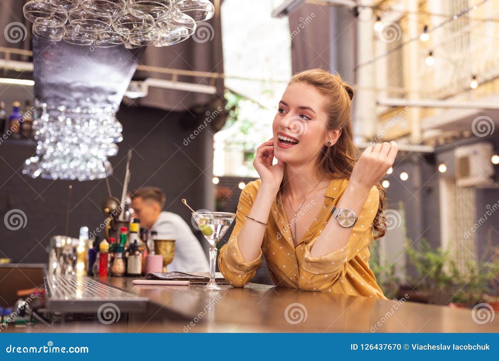 Expressive Young Girl Sitting at the Bar Counter and Looking Happy ...