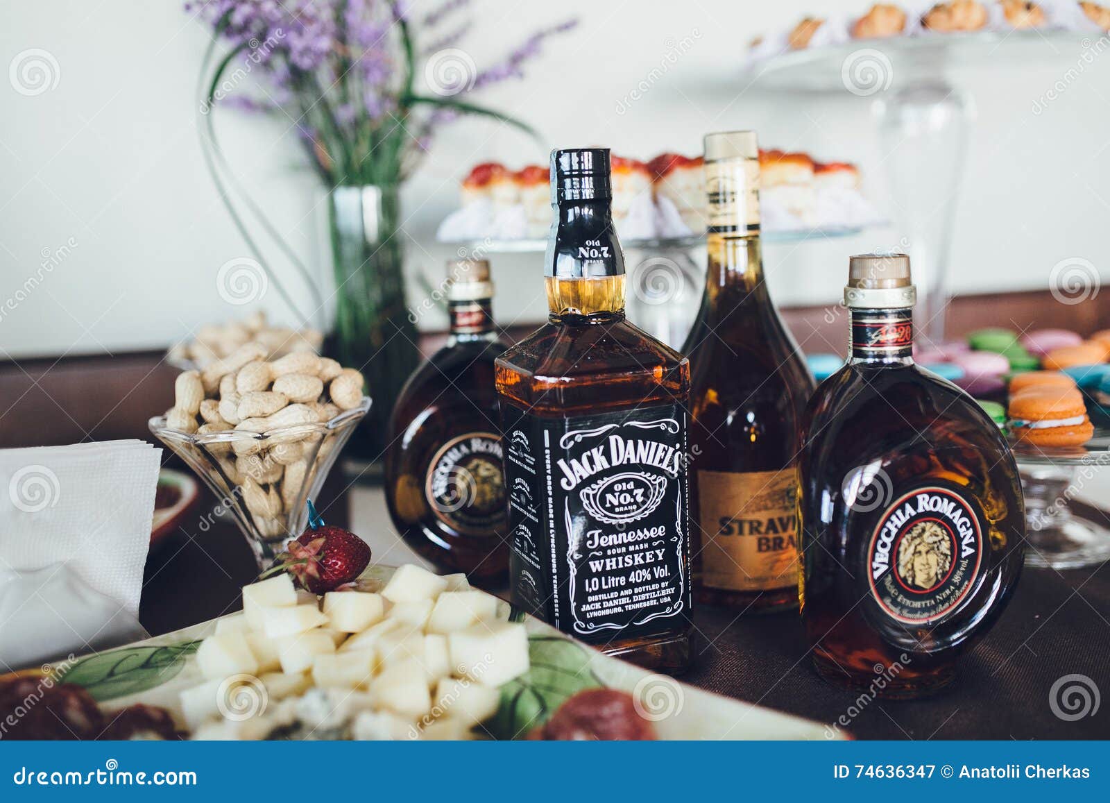 Exquisite Alcoholic Drinks and Snacks on Buffet Table Editorial