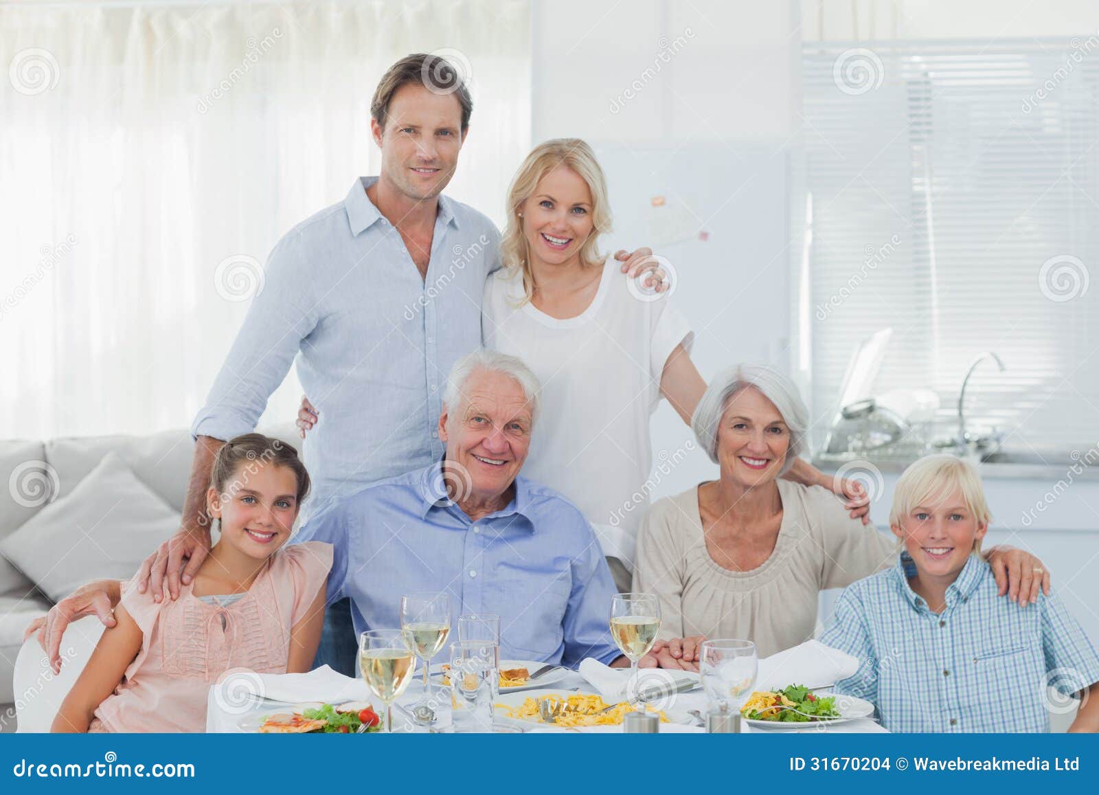 Extended Family Smiling at the Dinner Table Stock Photo Image of male