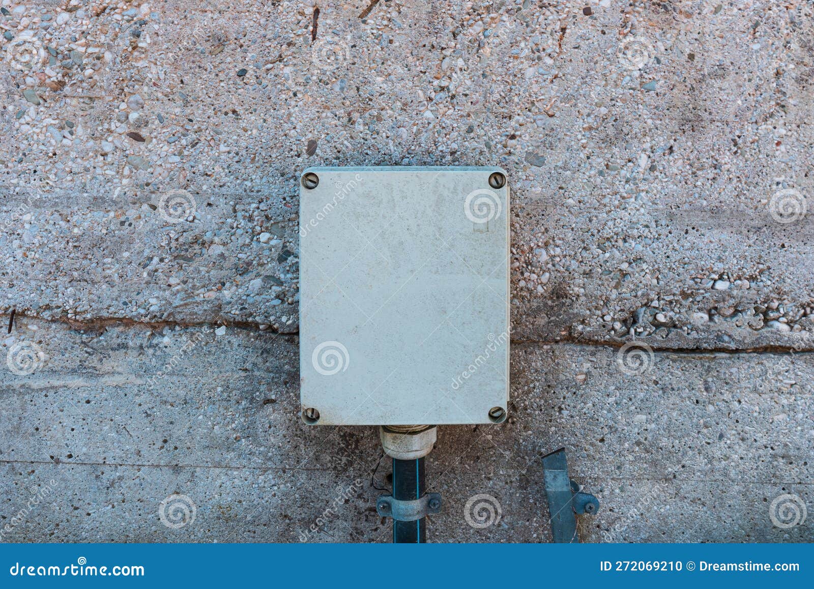 Exterior Plastic Electrical Box Mounted on Concrete Wall Stock Photo