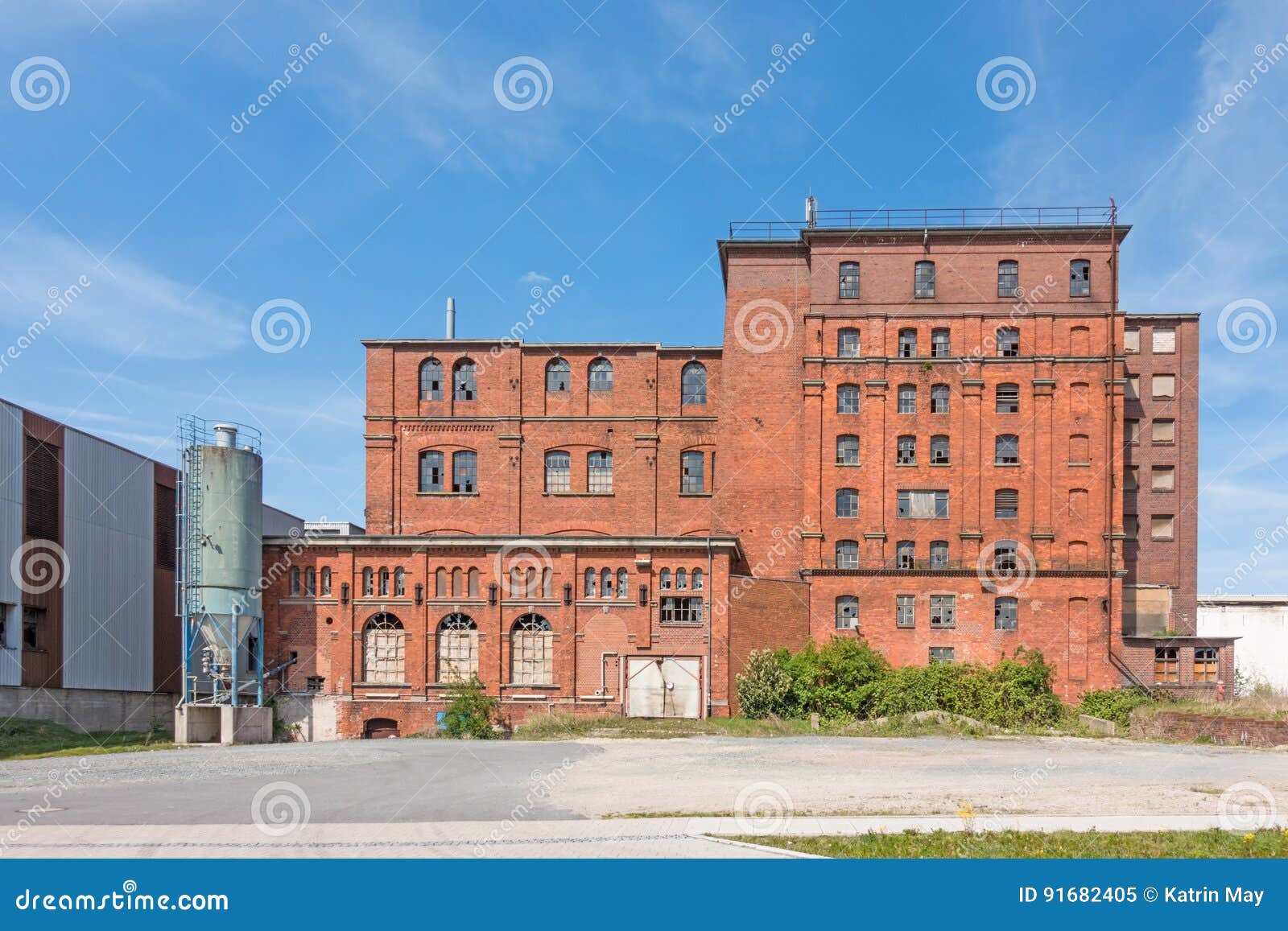 exterior view of a decayed factory building made of brick