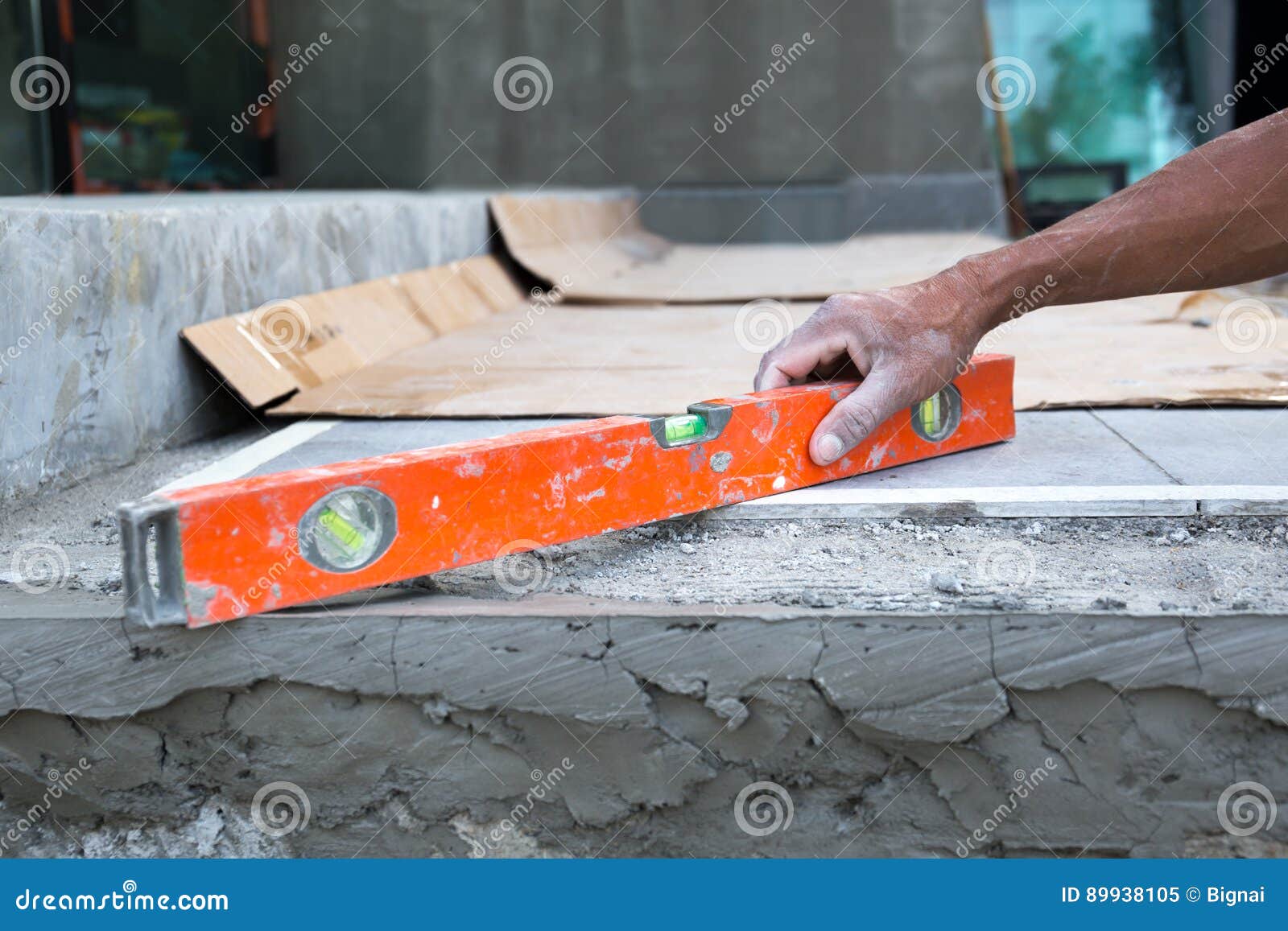 Exterior Worker Using Level For Laying Cement Floor Stock Image