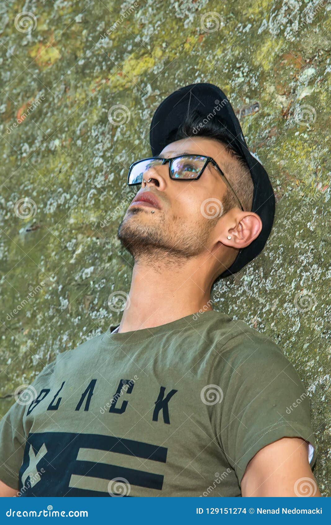 Extravagant Hipster Male Model with Glasses and Black Hat Leaning ...