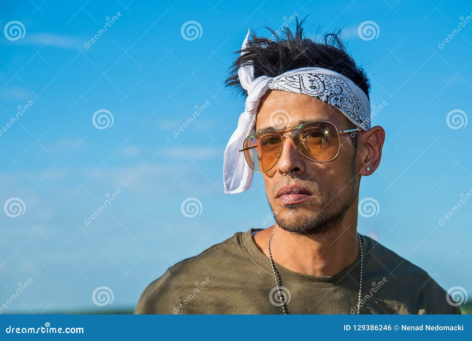 Modern adult hipster African American male in trendy outfit and in  sunglasses with dreadlocks smoking electronic cigarette standing on the  street Stock Photo - Alamy