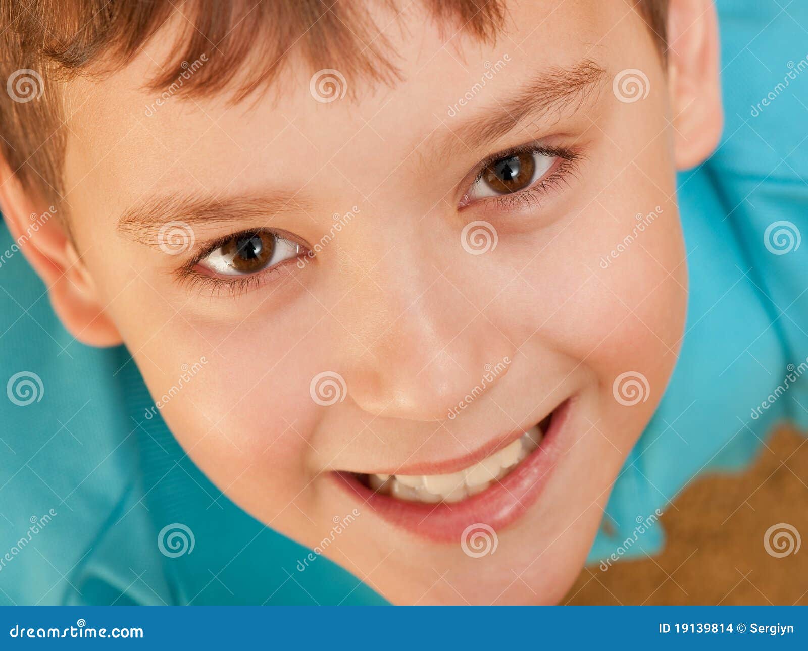 An extreame closeup portrait of a smiling boy; focus on the eyes