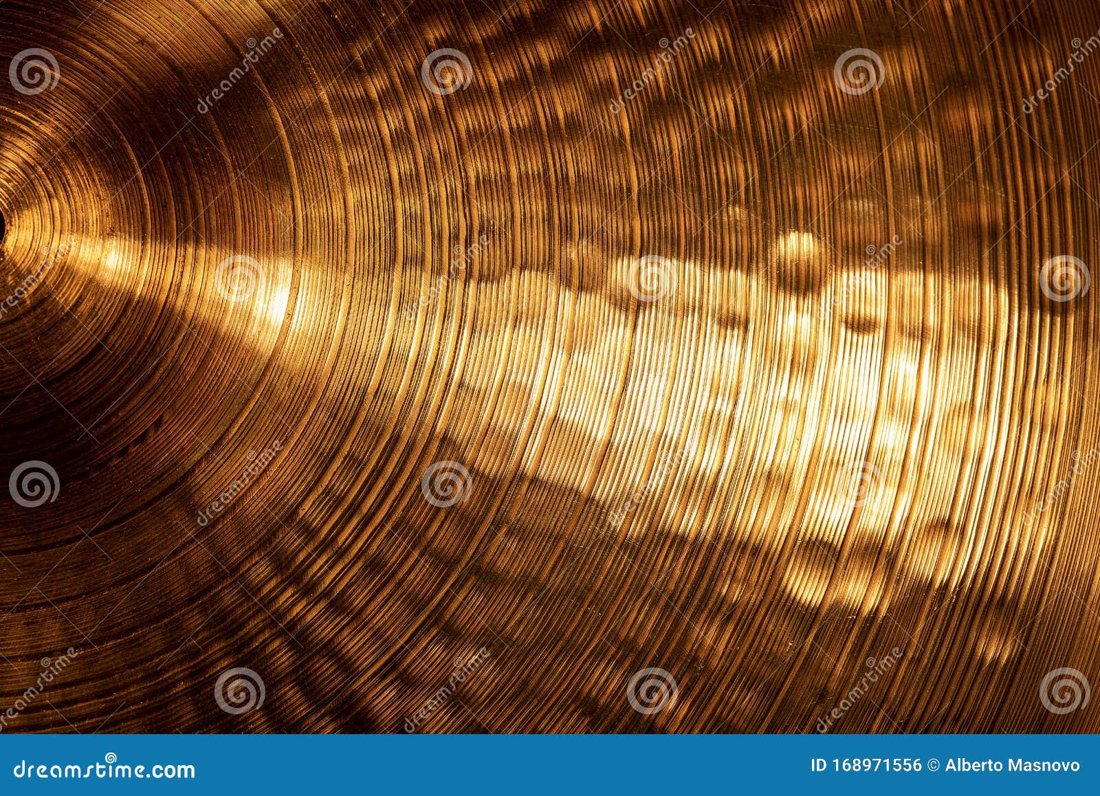 extreme close-up of an old golden cymbal of drum kit