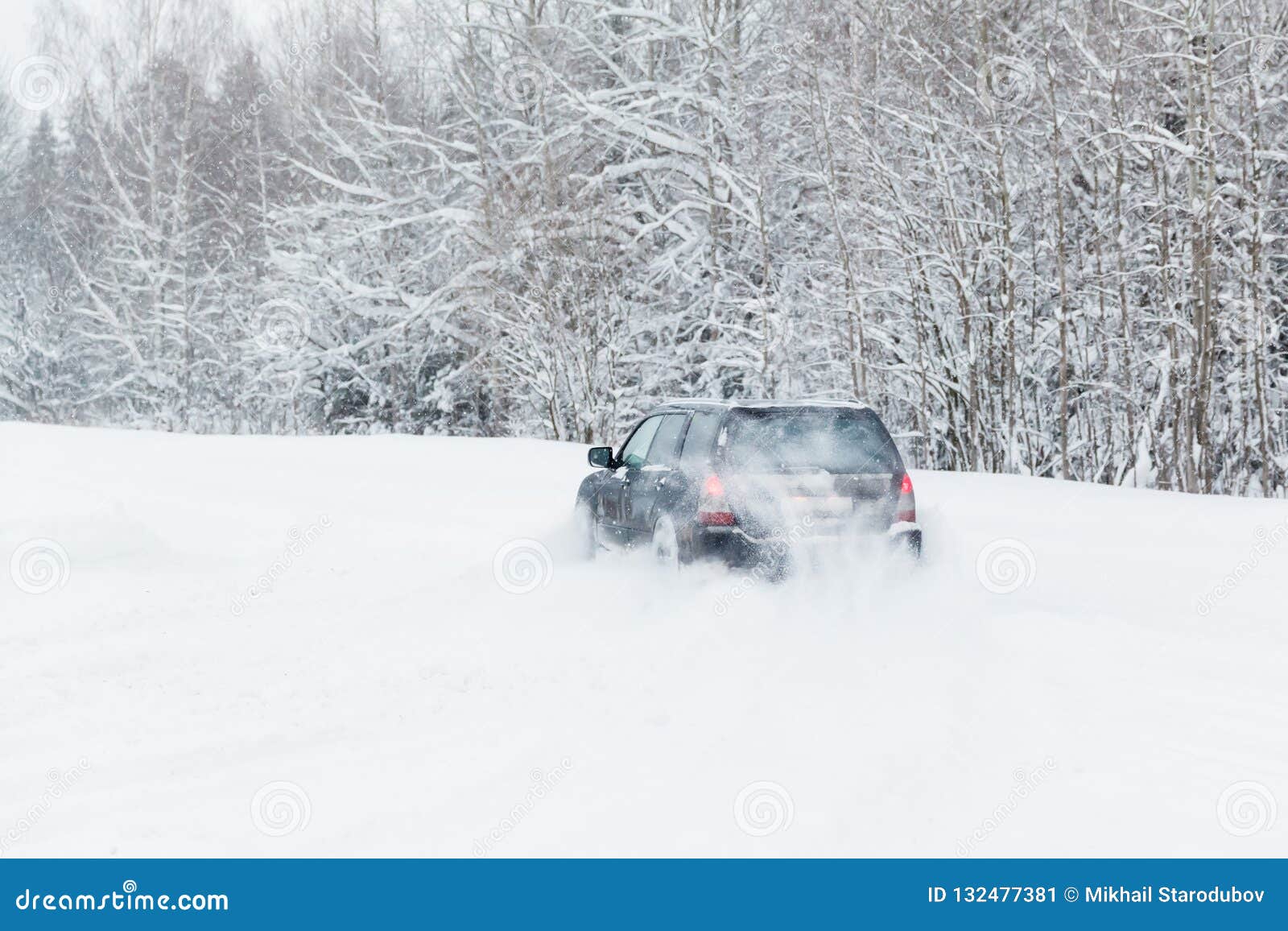 Extreme Driving, the Car is Moving Rapidly Over the Smooth Snow and Creates a Spray of Snow