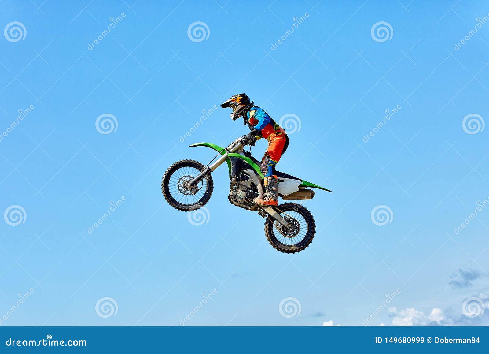 extreme sports, motorcycle jumping. motorcyclist makes an extreme jump against the sky.