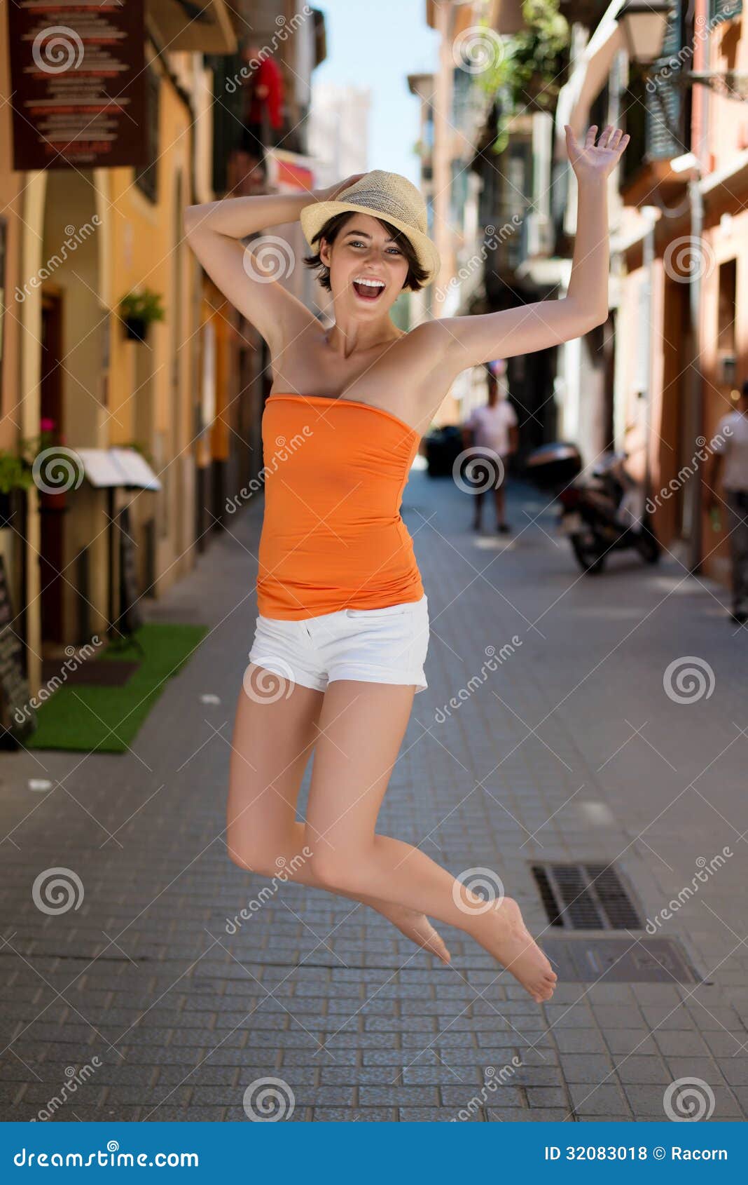 https://thumbs.dreamstime.com/z/exuberant-young-woman-jumping-joy-high-spirited-narrow-urban-street-summer-sunhat-shorts-bare-feet-32083018.jpg