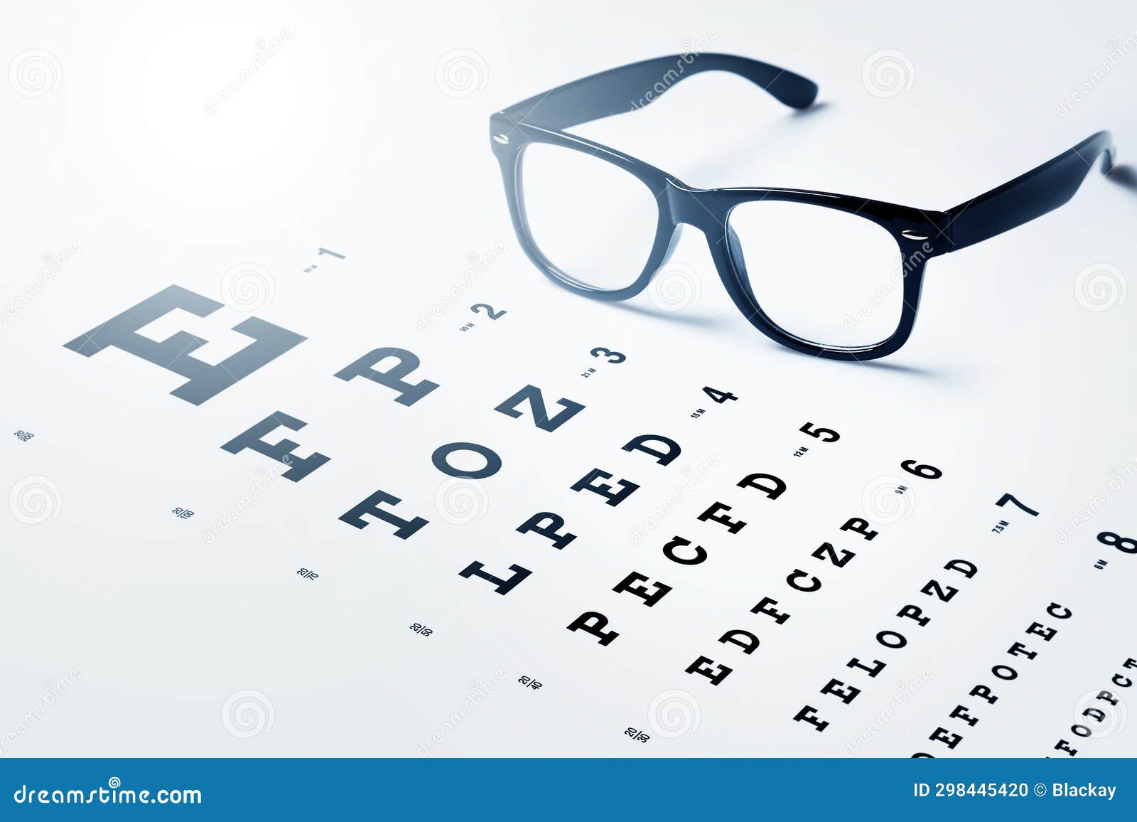 Eye Chart for Visual Acuity Testing and Black Rimmed Eyeglasses Stock
