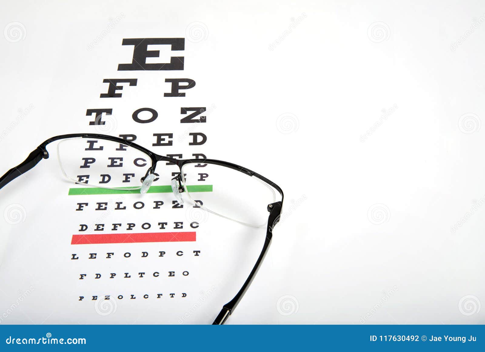 Eye Glasses on Eyesight Test Chart Background Close Up. Stock Photo