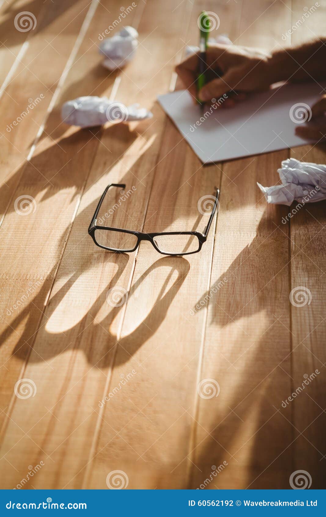Eye Glasses by Man Writing at Desk in Office Stock Photo Image of